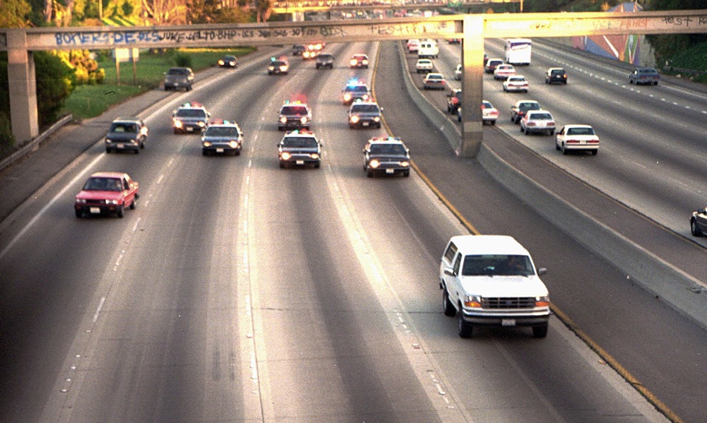 TIME FOR MOVEMENT AT 1 AM EDT MONDAY, JUNE 12 FILE - In this June 17, 1994 file photo, a white Ford Bronco, driven by Al Cowlings carrying O.J. Simpson, is trailed by Los Angeles police cars as it travels on a freeway in Los Angeles. Simpson's ex-wife, Nicole Brown Simpson, and her friend Ronald Goldman are found dead in Los Angeles. Simpson is later arrested after a widely televised freeway chase in his white Ford Bronco. (AP Photo/Joseph Villarin, File)