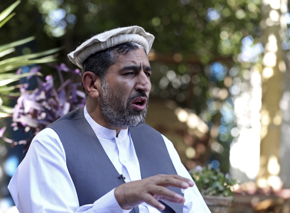 In this Thursday, May 30, 2019, photo, Ajmal Omar a member of the Nangarhar provincial council speaks during an interview with the Associated Press in the city of Jalalabad east of Kabul, Afghanistan, (AP Photo/Rahmat Gul)