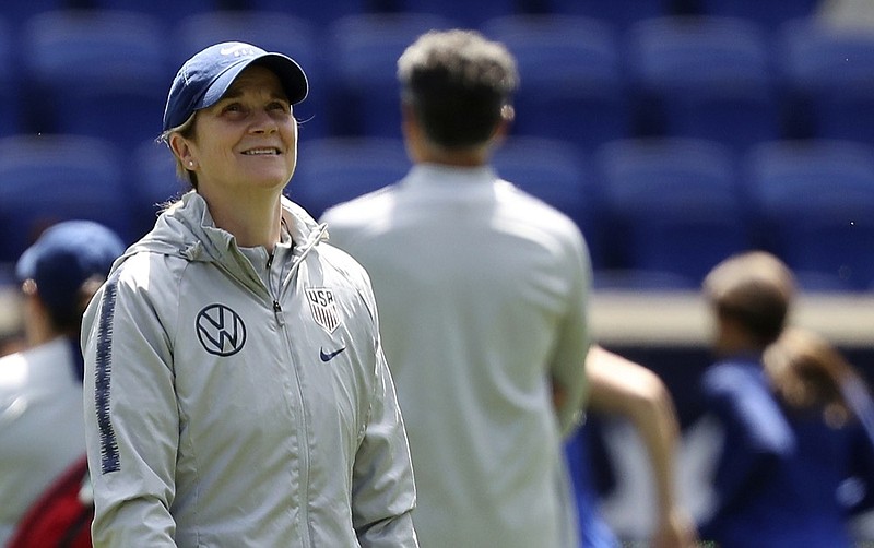 FILE - In this Saturday, May 25, 2019, file photo, United States women's national soccer team head coach Jill Ellis smiles during a training session at Red Bull Arena in Harrison, N.J. Ellis has criticized FIFA, soccer's international governing body, for scheduling two other finals, for the CONCACAF Gold Cup and the Copa America, on the same day as the Women's World Cup championship game. (AP Photo/Steve Luciano, File)