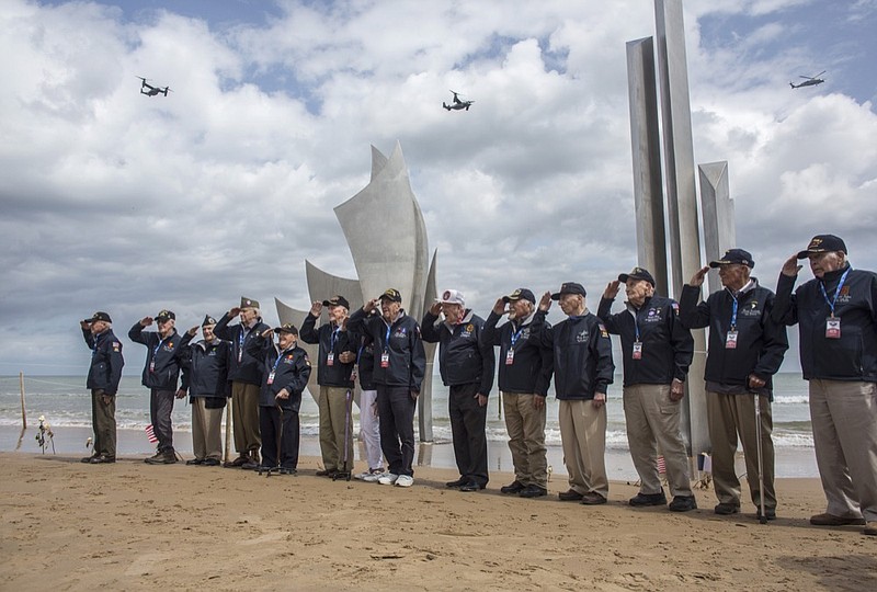 FILE - In this June, 3, 2019, file photo, World War II veterans from the United States salute as they pose in front of Les Braves monument at Omaha Beach in Saint-Laurent-sur-Mer, Normandy, France. Ceremonies marking the 75th anniversary of D-Day reminded us that an entire generation is fading from the world stage. (AP Photo/Rafael Yaghobzadeh, File)

