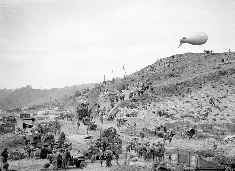 FILE - In this June 10, 1944, file photo, U.S. troops move inland from an established beachhead at Omaha Beach in the Normandy region of France. Ceremonies marking the 75th anniversary of D-Day in June 2019, reminded us that an entire generation is fading from the world stage. (AP Photo/Jack Rice, File)

