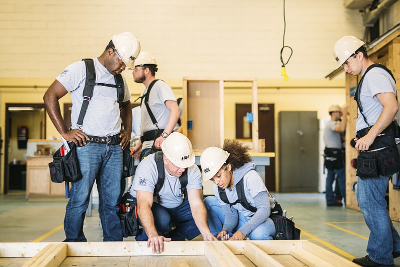 This photo provided by The Home Depot shows students training at the The Home Depot Foundation and HBI's Ft. Stewart Program on a job site in Ft. Stewart, Ga. The Home Depot Foundation announced last year that it was committing $50 million to skilled trades training with plans to attract 20,000 people by 2028. (Julia Fenner/Leggybird Photography/The Home Depot via AP)