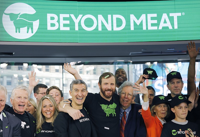 FILE - In this May 2, 2019, file photo Ethan Brown, center, CEO of Beyond Meat, attends the Opening Bell ceremony with guests to celebrate the company's IPO at Nasdaq in New York. After another two-day surge, shares in Beyond Meat are now selling for more than six times their $25 IPO price early last month. But some are beginning to wonder if they’re finally priced beyond their actual value. JPMorgan on Tuesday, June 11 downgraded the stock from buy to neutral. (AP Photo/Mark Lennihan, File)