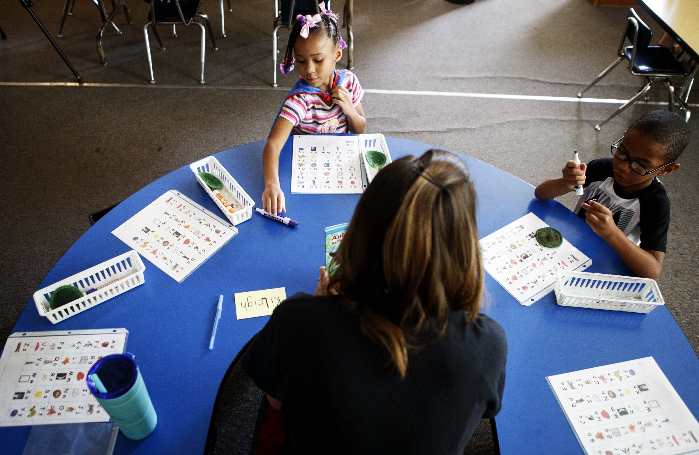 Teacher Kelly Piazza, bottom, works with KiLeigh, top, and Halo during Camp K at Bess T. Shepherd Elementary School on Tuesday, June 11, 2019 in Chattanooga, Tenn. During the month of June, Camp K is providing over 400 rising kindergartners across 15 Hamilton County public schools access to foundational English and literacy skills and social-emotional experiences.