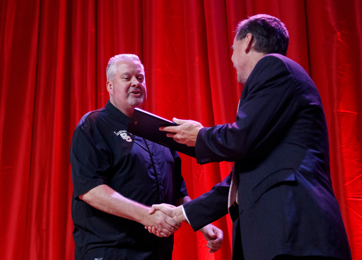 David Paschall, right, awards Bradley Central coach with the Scrappy Moore Coach of the Year award during the Times Free Press's Best of Preps Banquet at the Chattanooga Convention Center on Tuesday, June 11, 2019, in Chattanooga, Tenn. Former Tennessee basketball player Admiral Schofield was the guest athlete at the dinner honoring area high school athletes.