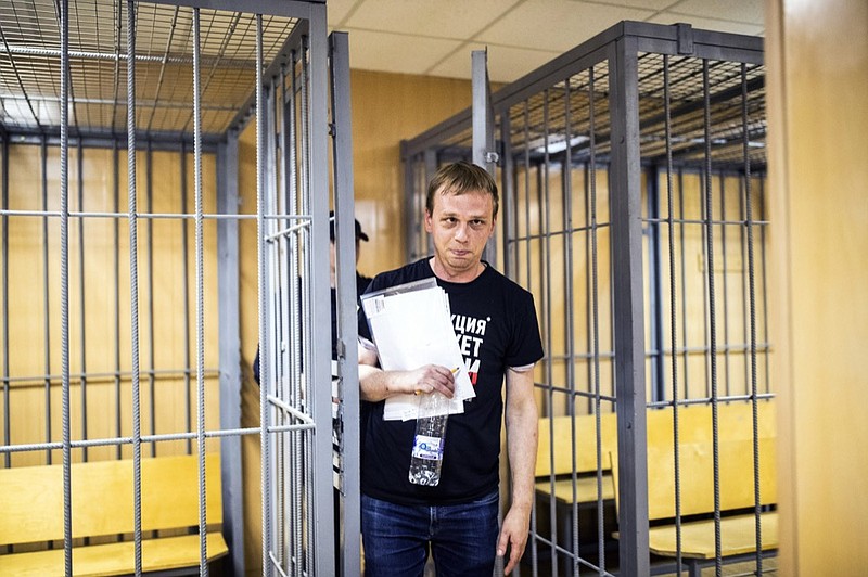 In this photo taken on Saturday, June 8, 2019, Ivan Golunov, a prominent Russian investigative reporter, who worked for the independent website Meduza, leaves the cage in a court room in Moscow, Russia. Golunov left the courtroom after the ruling to place him under house arrest until Aug. 7. In the court hearing, he denied being involved with drugs and said he would be willing to help investigators. (Evgeny Feldman/meduza.io via AP)

