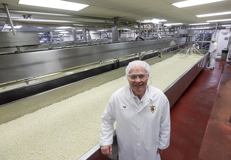 In this June 7, 2019, photo Jeff Schwager , president of Sartori Cheese poses for a picture at their plant in Plymouth, Wis. Schwager’s company, Sartori, faced retaliatory tariffs as President Donald Trump reopened a trade battle with Mexico to pressure the country into stopping the flow of Central American migrants to the U.S. border. The Plymouth, Wisconsin-based company already had to deal with 10 months of retaliatory tariffs from Mexico last year, and is also paying tariffs on sales to China. (AP Photo/Morry Gash)