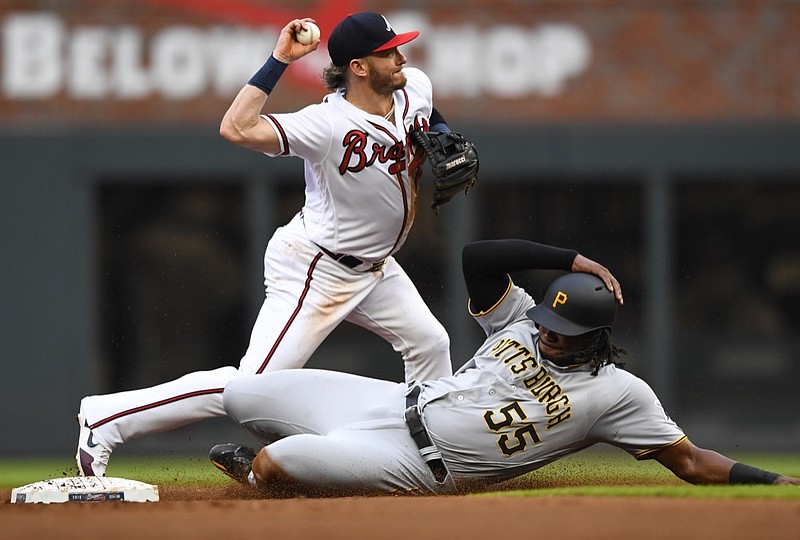 Atlanta Braves third baseman Josh Donaldson forces out Pittsburgh Pirates' Josh Bell (55) before throwing out Colin Moran at first base for a double play during the first inning of a baseball game Tuesday June 11, 2019, in Atlanta. (AP Photo/John Amis)

