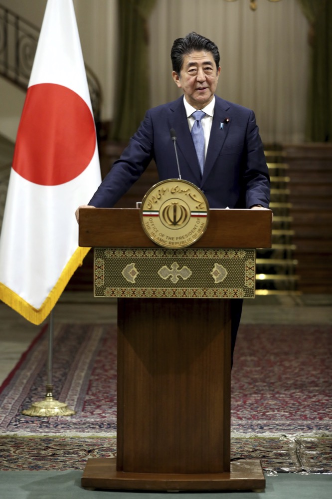 Japanese Prime Minister Shinzo Abe speaks with media during a joint press conference with Iranian President Hassan Rouhani, after their meeting at the Saadabad Palace in Tehran, Iran, Wednesday, June 12, 2019. The Japanese leader is in Tehran on an mission to calm tensions between the U.S. and Iran. (AP Photo/Ebrahim Noroozi)