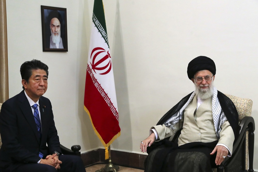 In this picture released by an official website of the office of the Iranian supreme leader, Supreme Leader Ayatollah Ali Khamenei, right, meets with Japanese Prime Minister Shinzo Abe, in Tehran, Iran, Thursday, June 13, 2019. A portrait of the late Iranian revolutionary founder Ayatollah Khomeini hangs on the wall. (Office of the Iranian Supreme Leader via AP)