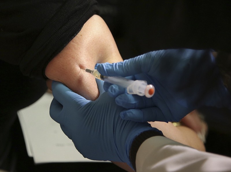 FILE - In this March 27, 2019 file photo, a woman receives a measles, mumps and rubella vaccine at the Rockland County Health Department in Pomona, N.Y., north of New York City. On Wednesday, June 5, 2019, federal health officials updated the U.S. measles case count, saying 1,001 illnesses have been reported since the beginning of the year. (AP Photo/Seth Wenig)

