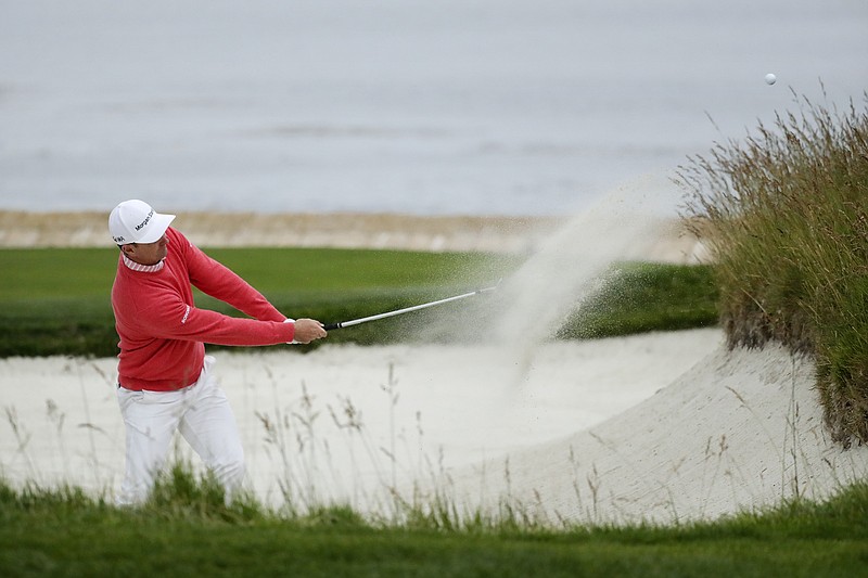 Justin Rose hits out of the bunker on the 18th hole at Pebble Beach Golf Links during Thursday's first round of the U.S. Open in California.