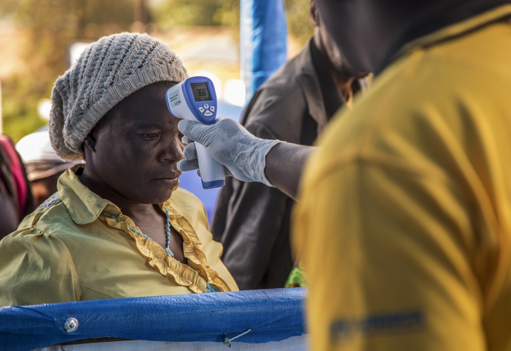 In this photo released by the International Rescue Committee (IRC), Congolese refugees are screened for Ebola symptoms at the IRC triage facility in Kyaka II refugee settlement in Kyegegwa District in western Uganda Thursday, June 13, 2019. The Congolese pastor who is thought to have caused the Ebola outbreak's spread into Uganda was unknown to health officials before he died of the disease, the World Health Organization's emergencies chief said Thursday, underlining the problems in tracking the virus. (Kellie Ryan/International Rescue Committee via AP)