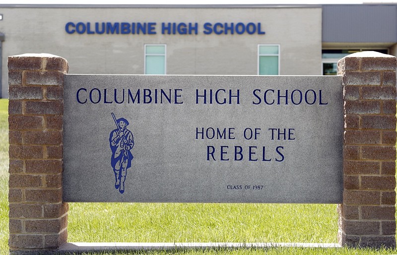 Signs outside Columbine High School are photographed, Thursday, June 13, 2019, in Littleton, Colo. The school district is considering the demolition of Columbine, the scene of a mass assault more than 20 years ago, and rebuilding the current school. (AP Photo/David Zalubowski)

