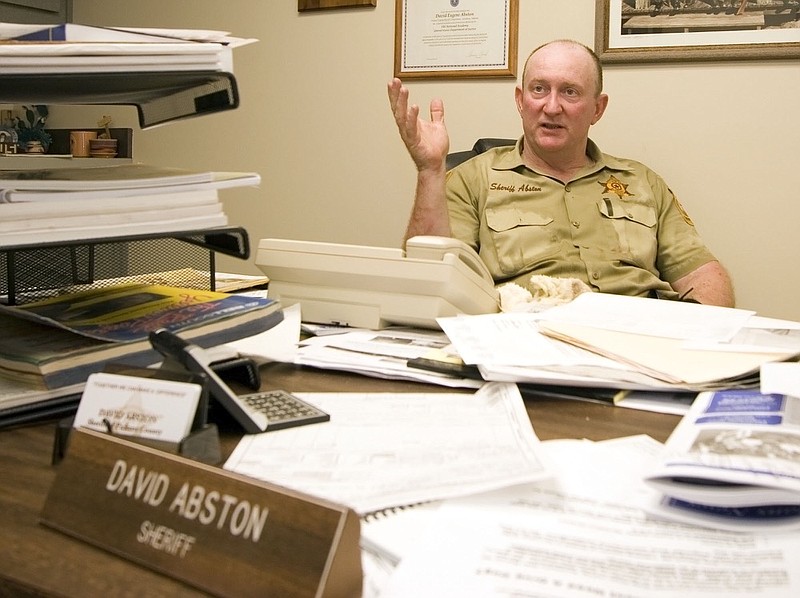 In this July 7, 2006 photo, Pickens County Sheriff David Abston speaks with reporters about a jailbreak in Carrollton, Ala. Court records show Abston was arrested Friday, June 14, 2019, and is pleading guilty to fraud and filing a false tax return. He is charged with scamming a food bank and his own church to pocket thousands under a law that let state sheriffs profit from feeding prisoners. (Dusty Compton/The Tuscaloosa News via AP)


