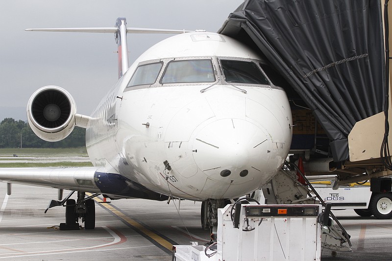 Staff file photo / A Delta Air Lines flight destined for Atlanta docks at Chattanooga Airport. Delta boardings in Chattanooga are up sharply so far in 2019, according to airport figures.