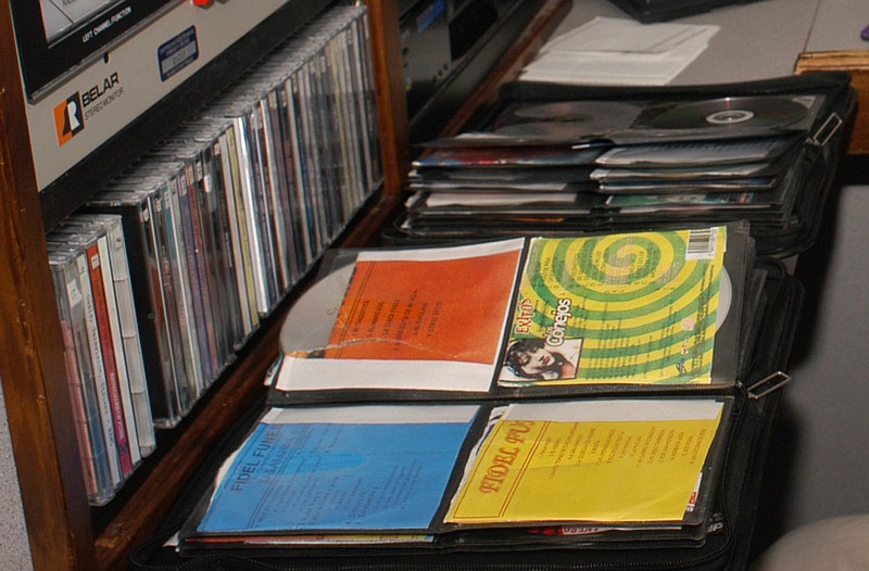 Electronic equipment and stacks of music CDds are shown in this staff file photo.