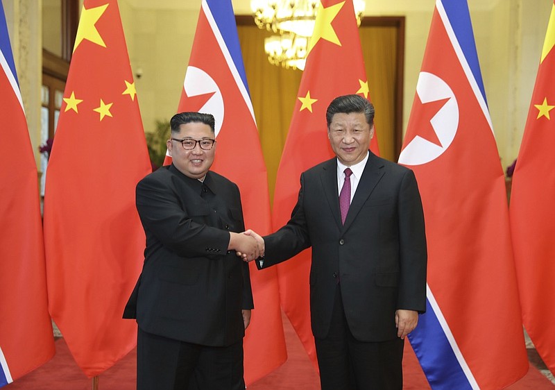 In this June 19, 2018, file photo released by China's Xinhua News Agency, Chinese President Xi Jinping, right, poses with North Korean leader Kim Jong Un for a photo during a welcome ceremony at the Great Hall of the People in Beijing. Chinese state media say President Xi Jinping will make a state visit to North Korea this week. State broadcaster CCTV said in its evening news program on Monday that Xi will meet with North Korean leader Kim Jong Un during a visit Thursday and Friday. (Ju Peng/Xinhua via AP, File)