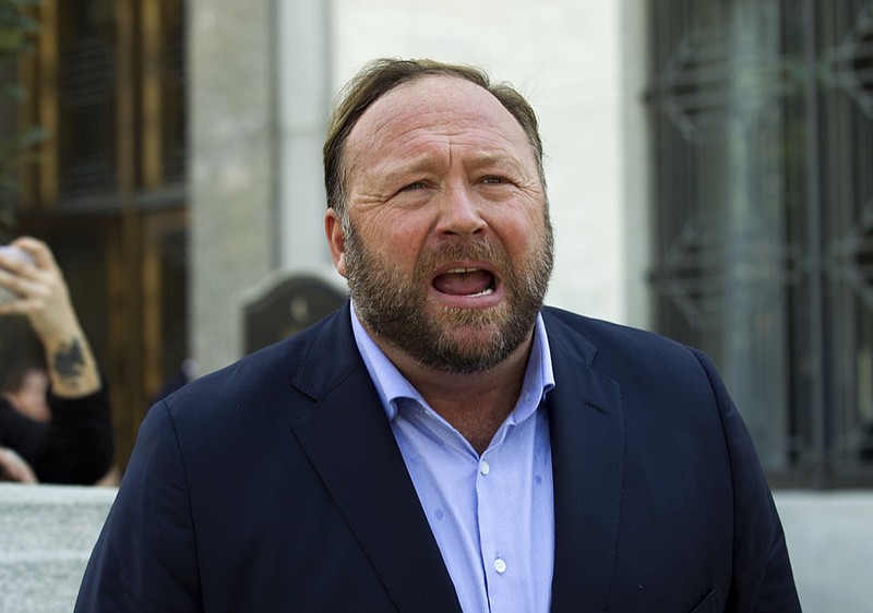 In this Sept. 5, 2018, file photo, Alex Jones speaks to reporters in Washington. Lawyers in Connecticut, on Monday, June 17, 2019, allege conspiracy theorist Alex Jones sent them electronic files containing child pornography as part of a defamation lawsuit against the Infowars host by relatives of some victims of the Sandy Hook Elementary School shooting. The families of eight victims of the 2012 shooting in Newtown, Conn. and an FBI agent who responded to the massacre are suing Jones, Infowars and others for promoting a theory that the shooting was a hoax. (AP Photo/Jose Luis Magana, File)