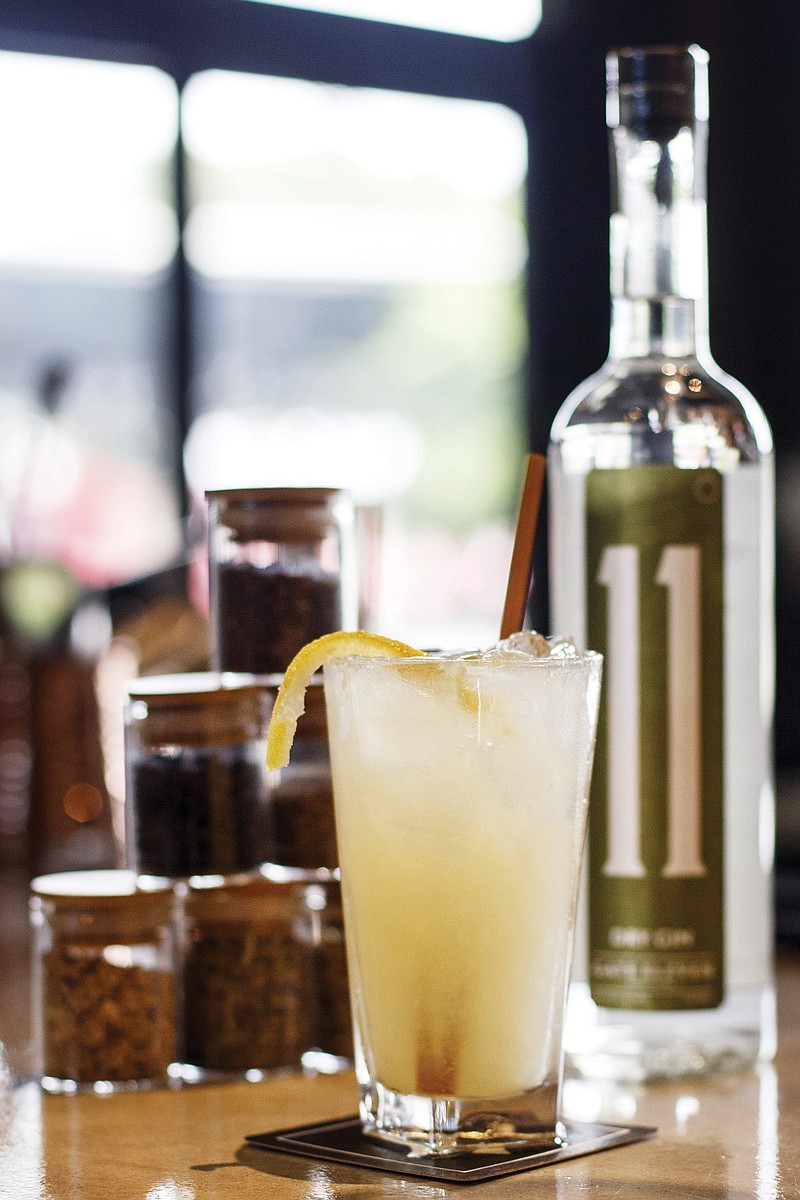 The Bumblebee Sting, a drink made with gin, honey simple syrup, lavender-chamomile simple syrup, elderflower, sparkling water, lemon juice and garnished with a candied lemon peel, is seen at the Gate 11 Distillery, inside the Chattanooga Choo Choo, on Wednesday, May 1, 2019 in Chattanooga, Tenn. The drink is made with Gate 11's gin and photographed with some of the botanicals used to distill the gin.