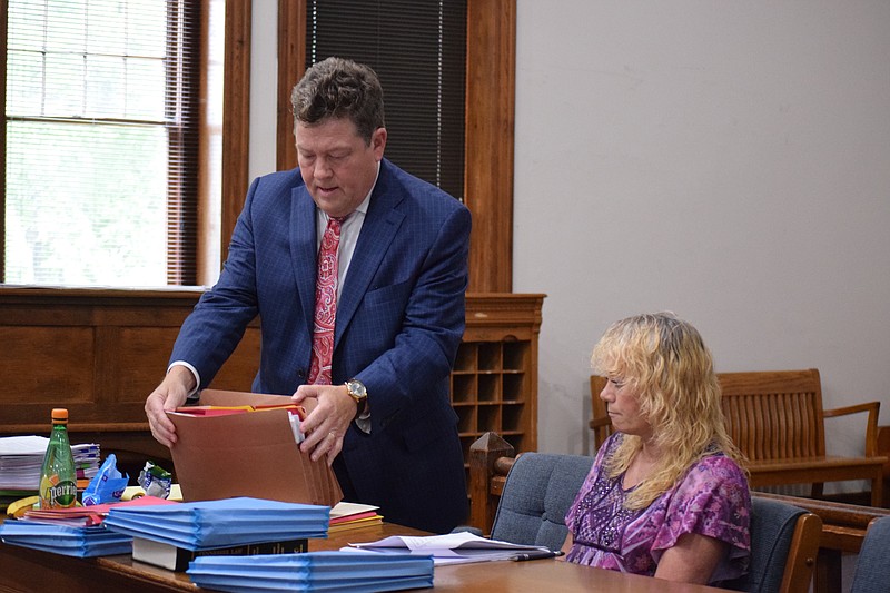 Patricia Kaye Wilkey, seated, listens to her lawyer, Chattanooga-attorney Marty Lasley, before court proceedings begin on Wednesday, June 19, 2019. Wilkey, 52, is on trial for first-degree murder in the 2017 slaying of her husband, 51-year-old Thomas Richard "Skipper" Wilkey Jr.