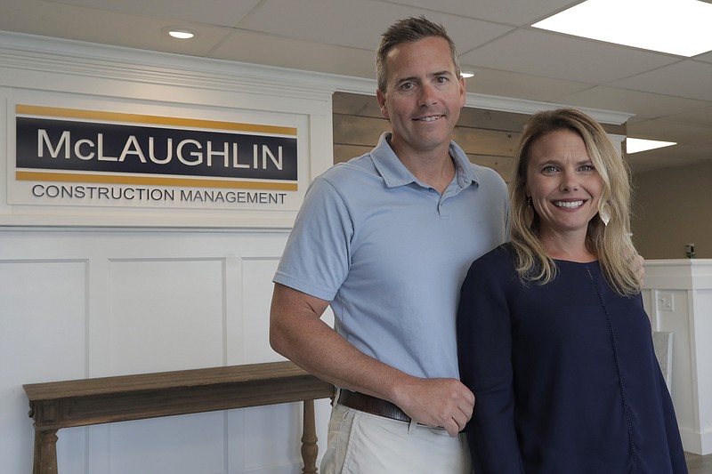 In this Wednesday, June 5, 2019, photo, Chris Carr, left, president of McLaughlin Construction Management, poses for a photo with his wife Kristy Carr in their office in Sea Isle City, N.J. When Kristy's father Jim McLaughlin died suddenly from a heart attack at age 64, his family assumed they would have to close his homebuilding business. But as McLaughlin’s son-in-law, Chris, started to wind down the Sea Isle City, New Jersey, company five years ago, he realized it was worth keeping open and that he, an accountant, should try to run it. (AP Photo/Julio Cortez)