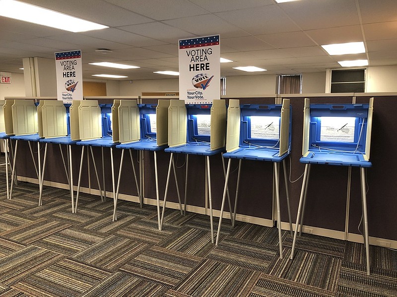 In this Sept. 20, 2018 photo, voting booths stand ready in downtown Minneapolis for the opening of early voting in Minnesota. A majority of Americans are concerned that a foreign government might interfere in some way in the 2020 presidential election, whether by tampering with election results, stealing information or by influencing candidates or voter opinion, a new poll shows.(AP Photo/Steve Karnowski)
