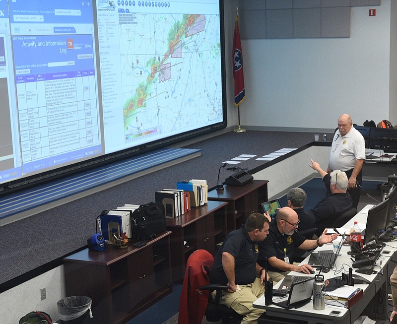A team of agencies including police and fire departments, Homeland Security, Tennessee Emergency Management Agency, Salvation Army and others monitor a severe storm's progress Wednesday, March 1, 2017, in the 911 call center building on Amnicola Highway.