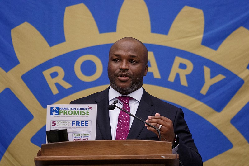 Staff photo by Doug Strickland / Hamilton County Schools Superintendent Bryan Johnson holds up a flyer about Hamilton County Promise during Rotary Club of Chattanooga meeting last week. Johnson and Hamilton County Mayor Jim Coppinger spoke about the county's school budget at the meeting.