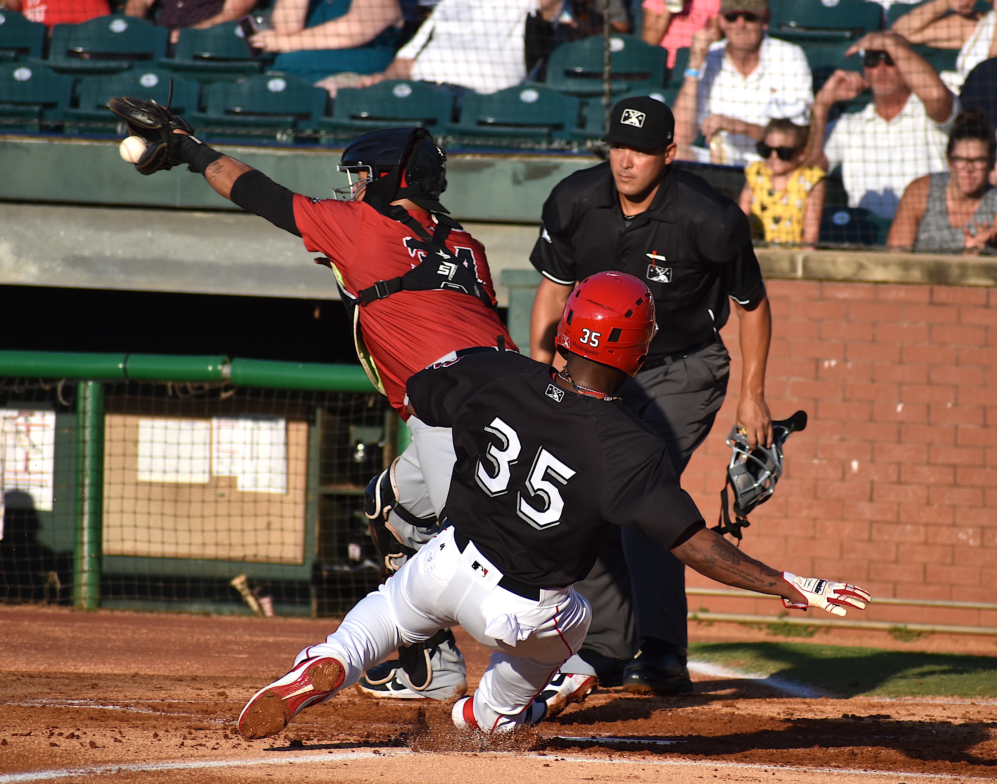 Chattanooga's Alfredo Rodriguez beats the throw to home plate during a Southern League baseball game against Birmingham at AT&T Field Thurdsay night. The Lookouts won 10-9 on a walk-off single by Michael Beltre.