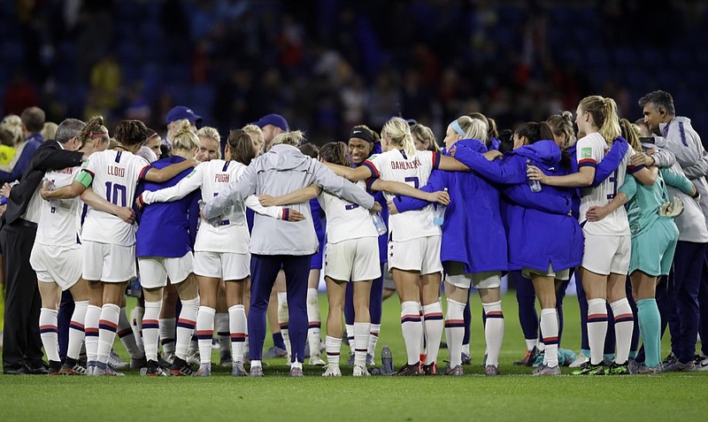 U.S. soccer coaches and players embrace after a 2-0 win over Sweden in a Women's World Cup Group F match Thursday at Stade Ocane in Le Havre, France.