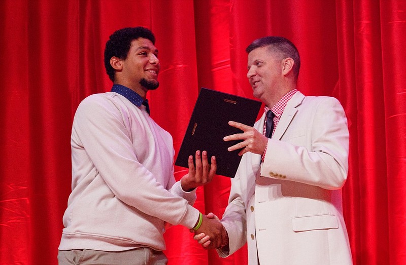 Stephen Hargis, right, awards Ringgold athlete Andre Tarver the Scrappy Moore Male Athlete of the Year award during the Times Free Press's Best of Preps Banquet at the Chattanooga Convention Center on Tuesday, June 11, 2019, in Chattanooga, Tenn. Former Tennessee basketball player Admiral Schofield was the guest athlete at the dinner honoring area high school athletes.