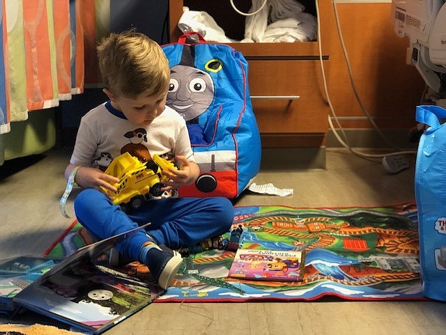 A Children's Hospital at Erlanger patient checks out a dump trunk and Thomas the Tank Engine-themed items provided by Dec My Room. / Contributed photo by Ashley Zani