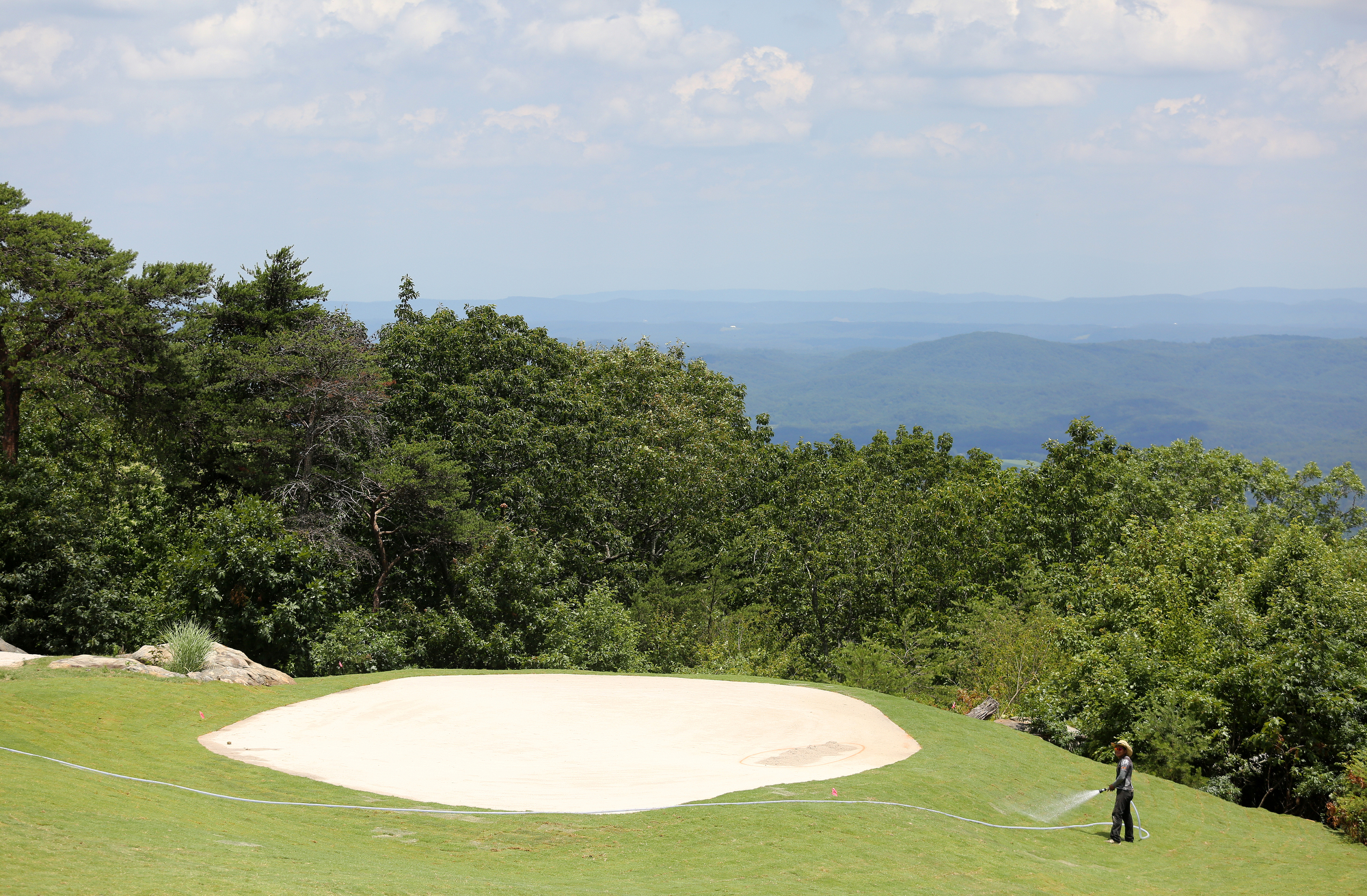 A worker waters the grass on The Course at McLemore on Lookout Mountain Friday, June 21, 2019 in Walker County, Ga. The clubhouse will open next spring with a golf pro shop, member locker room facilities along with private dining and event space.