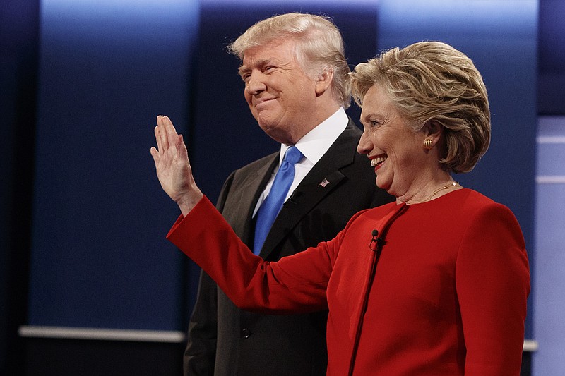 In this Sept. 26, 2016, file photo, then Republican presidential candidate Donald Trump, left, stands with then Democratic presidential candidate Hillary Clinton before the first presidential debate at Hofstra University in Hempstead, N.Y. Gearing up to take on Democratic front-runner Joe Biden, President Donald Trump sees echoes of his original political foe, Hillary Clinton.  (AP Photo/ Evan Vucci)