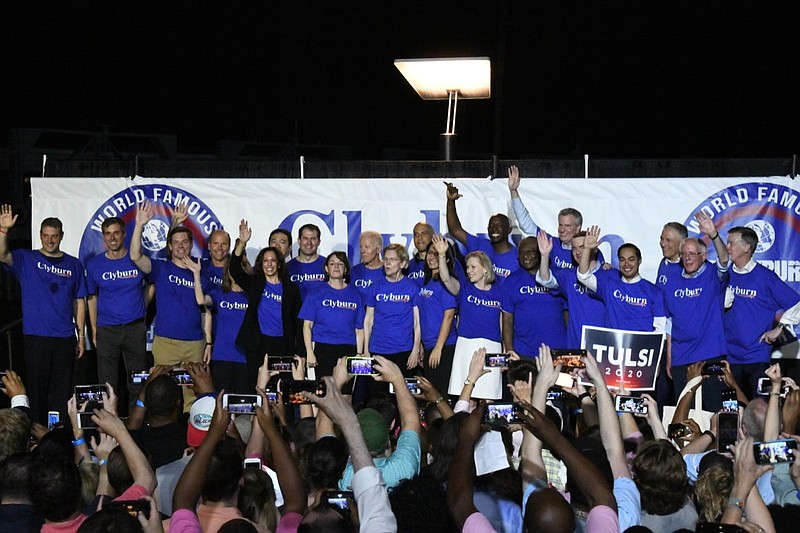 Twenty-one of the Democrats seeking the party's presidential nomination pose together after House Majority Whip Jim Clyburn's "World Famous Fish Fry," Friday, June 21, 2019, in Columbia, S.C. (AP Photo/Meg Kinnard)
