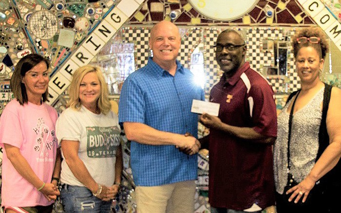 Adam Noll, class reunion leader and class historian of the Tyner High School Class of 1979 (center) presents a $2,000 donation to Tyner Academy teachers and administrators, from left, Rachel Cherry, Angela Williams, Gerald Harris and Cathy Butler after alumni raised the funds at a recent reunion event. Photo courtesy of Hamilton County Schools. Contributed Photo/Times Free Press