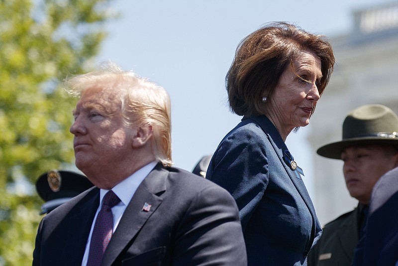 President Donald Trump and Speaker of the House Nancy Pelosi of California pass each other while attending the 38th annual National Peace Officers' Memorial Service at the U.S. Capitol in May.