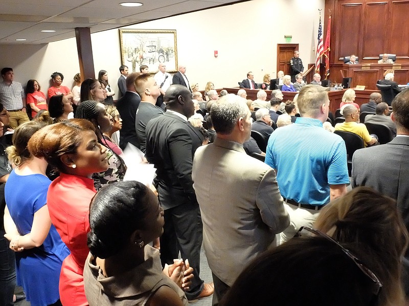 A standing room only crowd listens to viewpoints on a tax increase inside the Hamilton County Commission room on Wednesday morning. / Staff photo by Tim Barber 