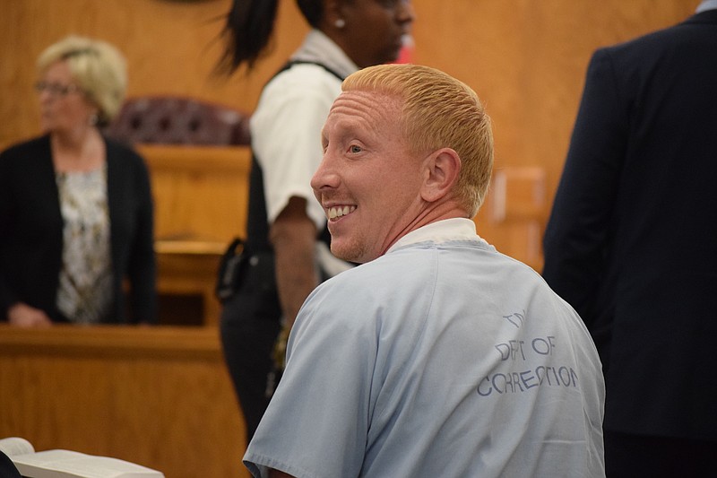 Adam Braseel, right, sits at the defense table in Grundy County Circuit Court on Wednesday, June 26, 2019, at the start of a hearing on his petition for a new trial. Braseel was convicted in 2007 of first-degree murder in the death of 60-year-old Malcolm Burrows.