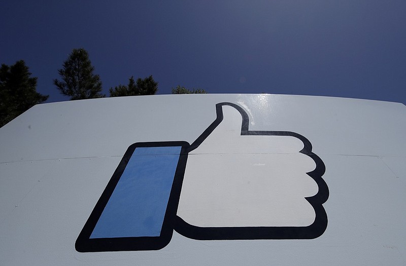 This April 25, 2019, file photo shows the thumbs-up "Like" logo on a sign at Facebook headquarters in Menlo Park, Calif. Facebook is updating its terms and services guidelines to clarify how it makes money from the personal information of its users. The updates will take effect July 31 for all Facebook users. (AP Photo/Jeff Chiu, File)