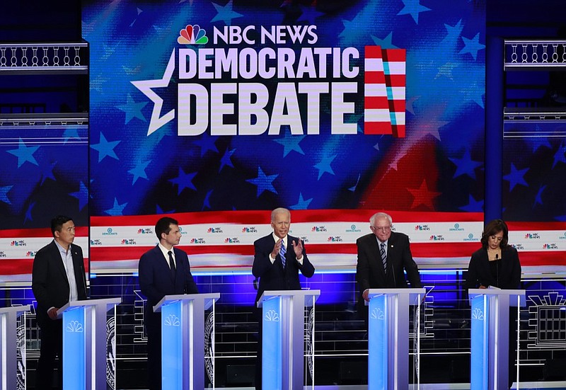 Democratic presidential candidate former vice president Joe Biden, center, speaks during the Democratic primary debate hosted by NBC News at the Adrienne Arsht Center for the Performing Art, Thursday, June 27, 2019, in Miami, as from left, entrepreneur Andrew Yang, South Bend Mayor Pete Buttigieg, fSen. Bernie Sanders, I-Vt., and Sen. Kamala Harris, D-Calif., listen. (AP Photo/Wilfredo Lee)