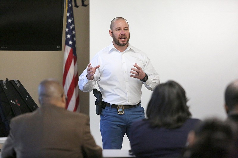 Chattanooga Police Sgt. Josh May, the supervisor of the gun unit, speaks with visitors from several out-of-town law enforcement agencies about the gun unit and the implementation of NIBIN at the Chattanooga Police Services Center Thursday, March 28, 2019 in Chattanooga, Tennessee. May discussed a variety of topics during the event revolving around establishing a preventative gun violence strategy. 