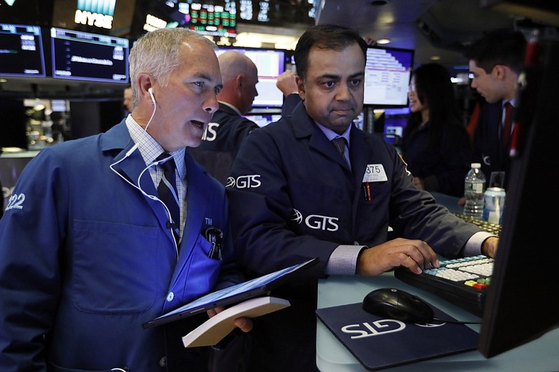 In this June 11, 2019, file photo trader Timothy Nick, left, and specialist Dilip Patel work on the floor of the New York Stock Exchange. The U.S. stock market opens at 9:30 a.m. EDT on Thursday, June 27. (AP Photo/Richard Drew, File)