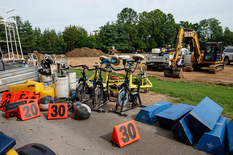 Football training equipment is seen near construction at UTC's Scrappy Moore Field on Wednesday. The school is removing old synthetic turf that covered half of the field and converting the entire practice field to a synthetic turf surface.