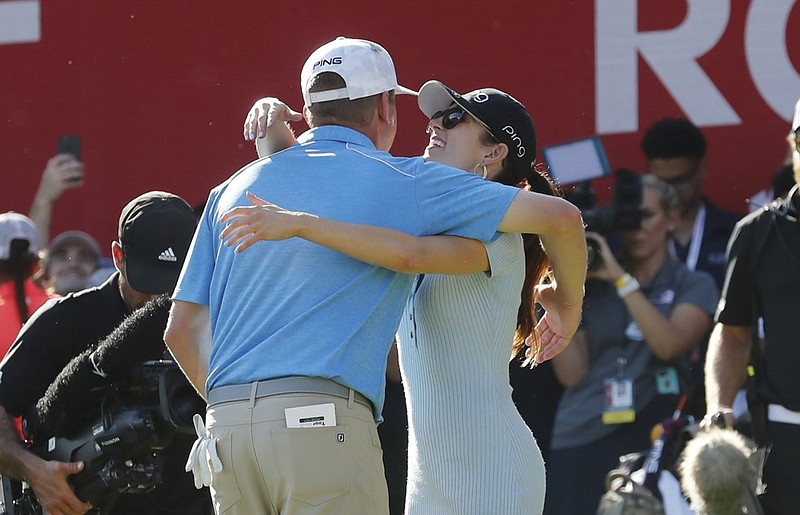 Nate Lashley hugs girlfriend Ashlie Reed on the 18th green at Detroit Golf Club after winning the Rocket Mortgage Classic on Sunday for his first PGA Tour title.