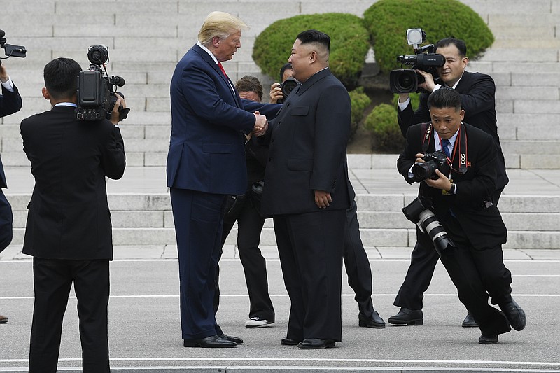 President Donald Trump walks to the North Korean side of the border with North Korean leader Kim Jong Un at the border village of Panmunjom in the Demilitarized Zone, Sunday, June 30, 2019, in North Korea. (AP Photo/Susan Walsh)