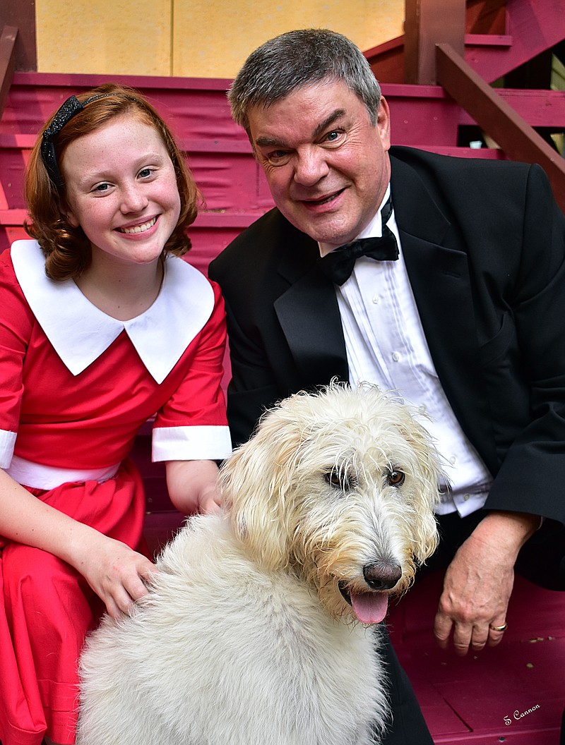 Ellie Lydon is Annie and Rob Inman plays Daddy Warbucks in the Signal Mountain Playhouse's production of "Annie." Playing Annie's dog Sandy is Luna, whose family is among actors in the cast. "She's done really well. She knows how to sit, come and lay down," says Ellie, who has been training with Luna using treats and hand signals, "but sometimes when she sees her family onstage, she wants to run to them." / Photo by Sheila Harding Cannon