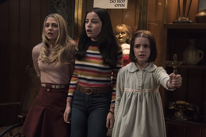 This image released by Warner Bros. Pictures shows Madison Iseman, from left, Katie Sarife and McKenna Grace in a scene from the horror film, "Annabelle Comes Home." (Dan McFadden/Warner Bros. Pictures via AP)