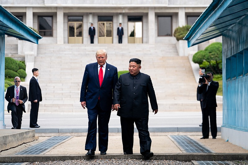 President Donald Trump and Kim Jong Un, the North Korean leader, cross from the North Korean side of the Demilitarized Zone into South Korea at Panmunjom on June 30, 2019. (Erin Schaff/The New York Times)